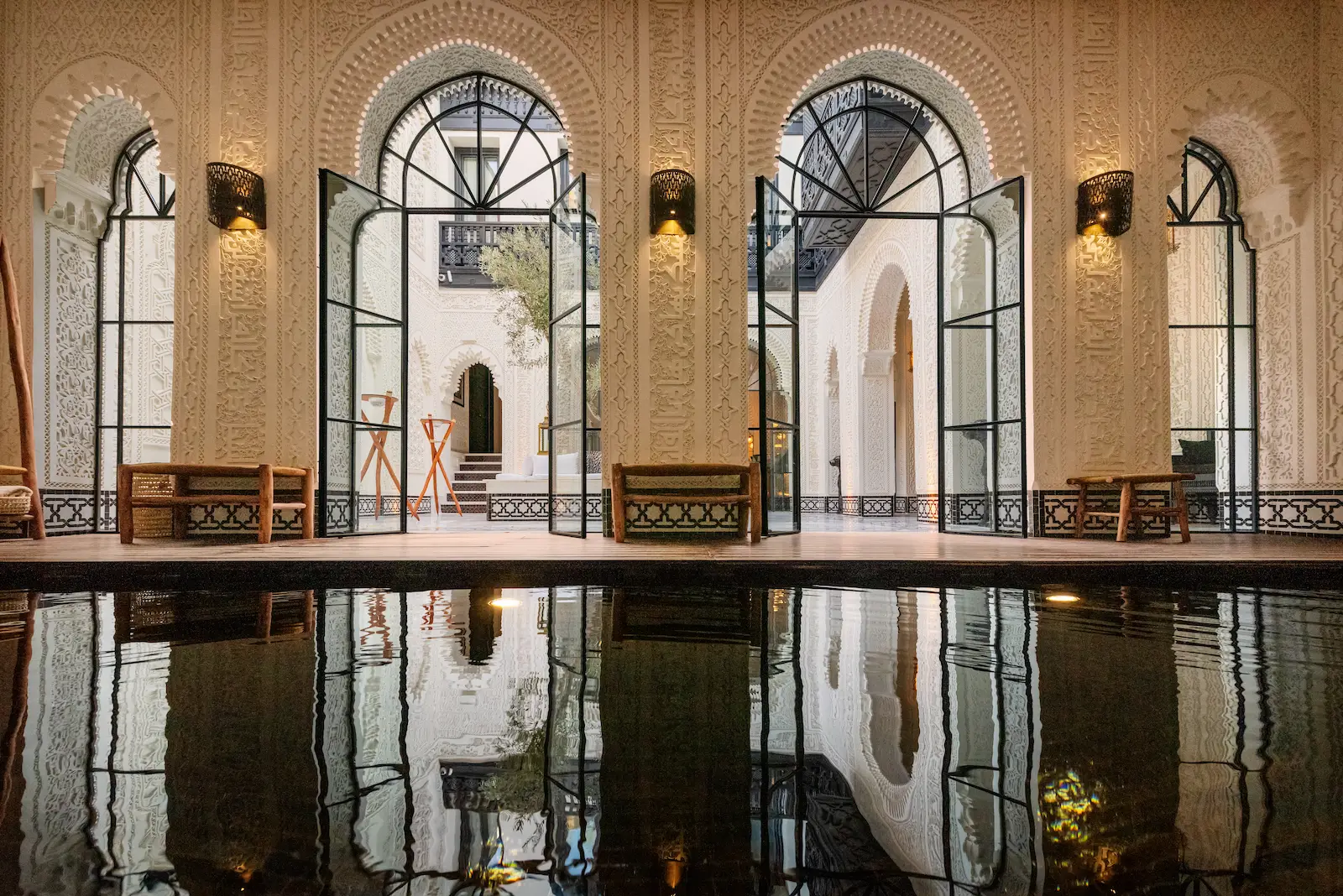 Luxury patio with arches and reflection pool at Riad Kheirredine Marrakech